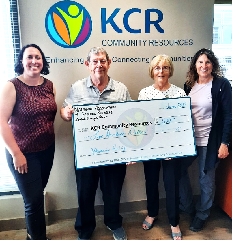 KCR Centre's Kaitlin Mitchell, and Ellen Boelcke (ends), presenting the cheque for $500 to Guy Bird and Jan Redlich (centre)