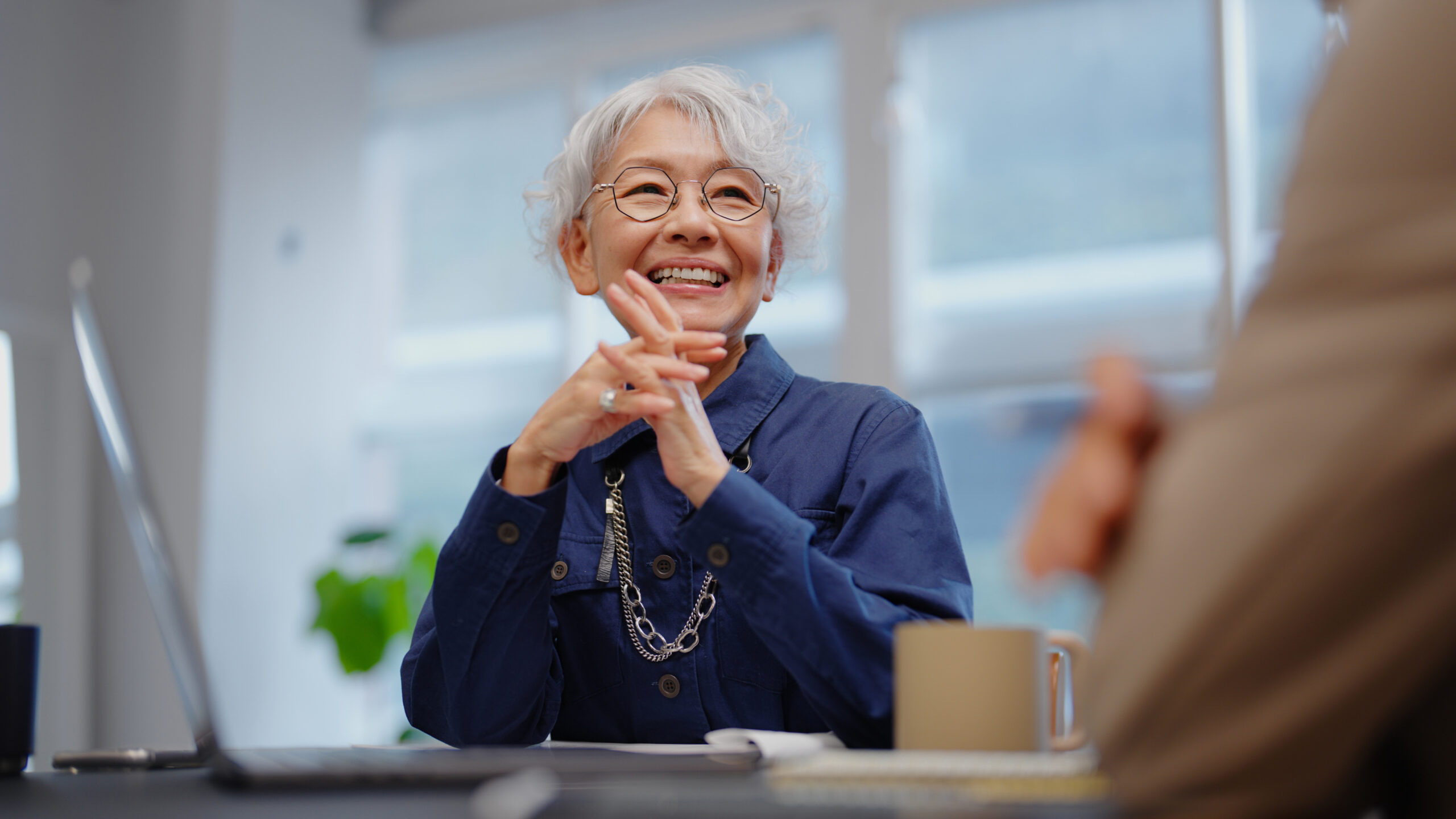 Older woman smiling at meeting